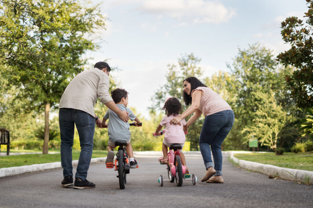 Family on bikes in a park