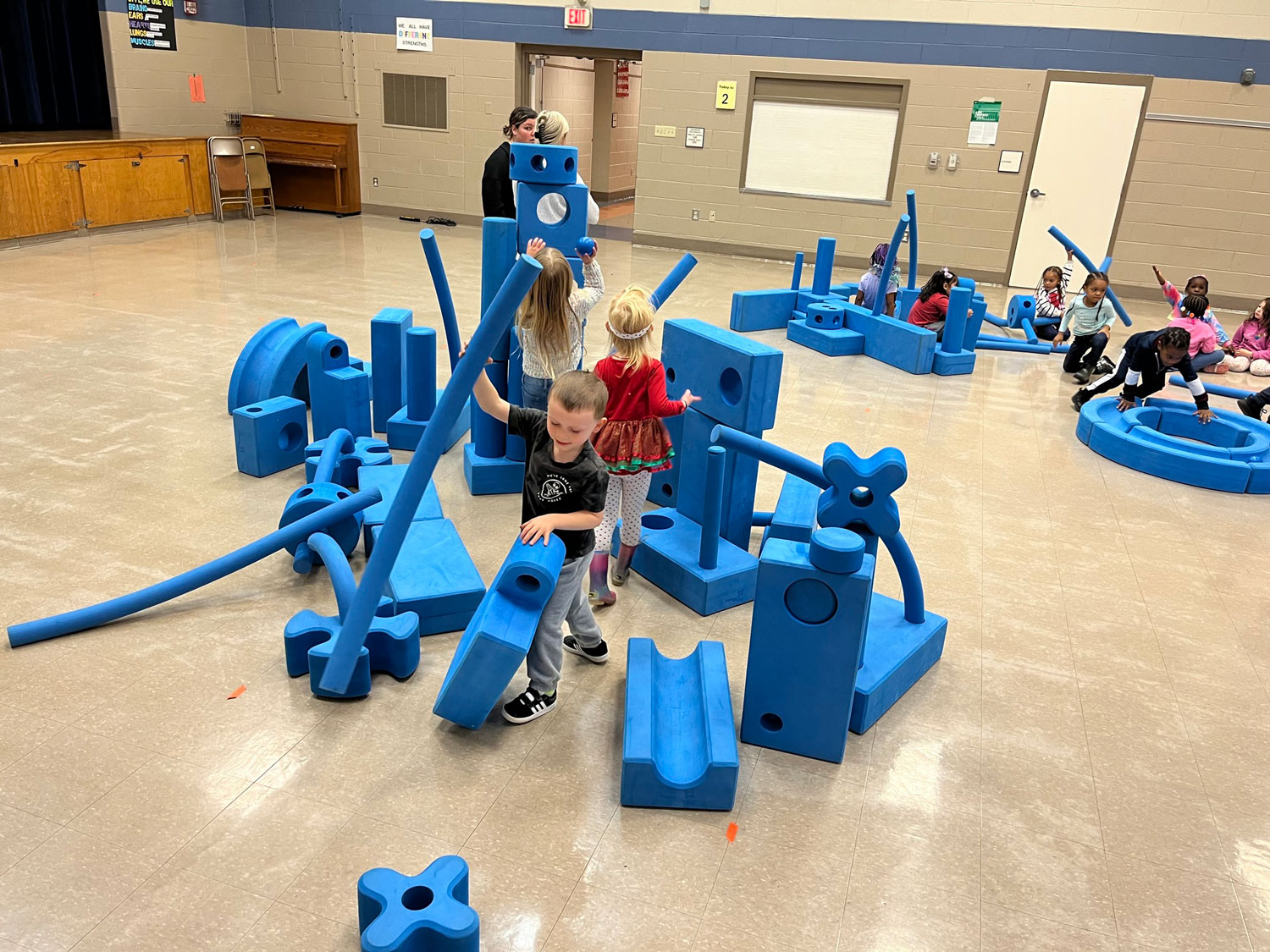 school children playing with developmental toys